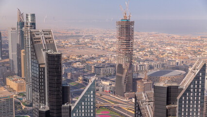Fototapeta premium Downtown skyline with modern architecture form above timelapse. Aerial view of Dubai business bay towers.