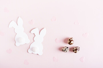 Naklejka na ściany i meble Happy easter card couple of white rabbits, quail eggs and hearts on pink top view