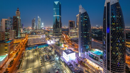 Fototapeta na wymiar Aerial view of Dubai International Financial District with many skyscrapers day to night timelapse.