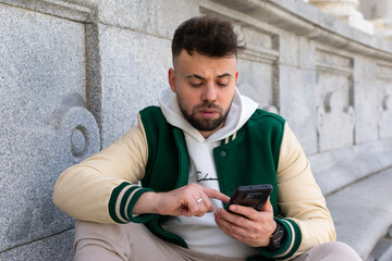 Close up unhappy irritated man in looking at phone screen, worried businessman reading bad news in message, confused young male having problem with broken or discharged device, data loss - obrazy, fototapety, plakaty