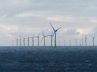 Offshore and Onshore Windmill farm Westermeerwind, Windmill park in the Netherlands with huge large wind turbines, group of windmills for renewable electric energy