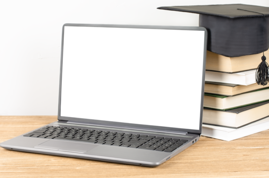 Laptop with blank display near the stack of book with graduation hat. E-learning and online graduation concept