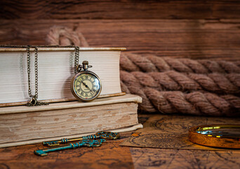 Old items, book, pocket watch, keys, magnifying glass, old maps, thick rope