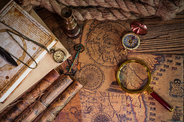 Old objects, book, magnifying glass, compass, pocket watch, spyglass, thick rope, old key lying on...