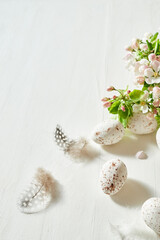 Holiday composition with spring flowers and easter eggs on a light background. Happy easter concept with copy space