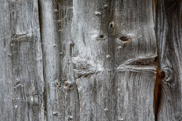 old wood background - planks with knotholes on an old barn