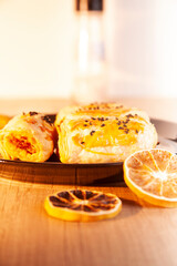 pastry, fritters on a black plate, wooden floor