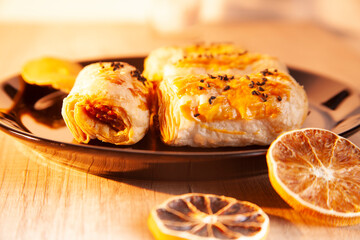 pastry, fritters on a black plate, wooden floor