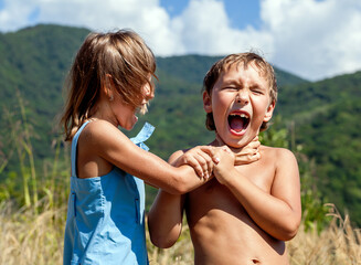 Angry boy and a girl scream and fight with each other outdoors - 588119325