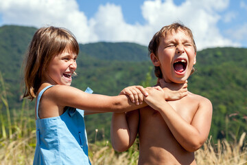 Angry boy and a girl scream and fight with each other outdoors - 588119343