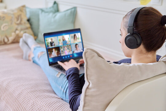 Video conference, teenage girl looking at laptop screen with group of students