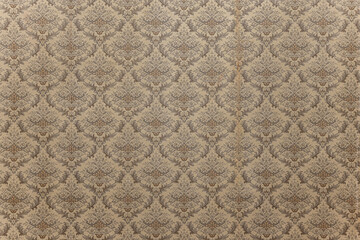 Old vintage wallpaper on the wall. Old wallpaper texture. Vintage style wall