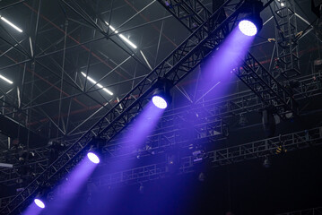 Bright rays of ultraviolet color at a concert. Concert light device. Moving head LED light