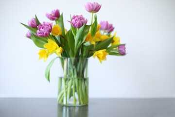 Tulips and narcissus in vase, home decor