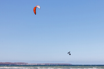 one kitesurfer surfing in stormy weather on the baltic sea