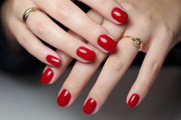 Red manicure with gel polish. Beautiful female nails.