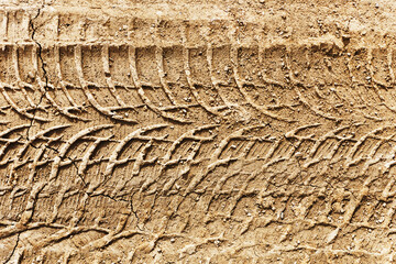 Sand tyre mark background. Tire track shape. Trail lines on dry brown sand pattern. Road construction site backdrop. Heavy machinery imprint. Dried mud vehicle wheel shape.