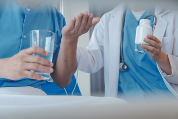 Women Asian doctors hold the patient hand and encourage and provide medical advice While checking...