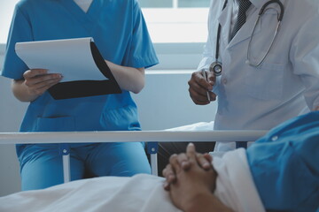 Women Asian doctors hold the patient hand and encourage and provide medical advice While checking...