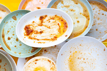 Dirty dishes on yellow background. Top view