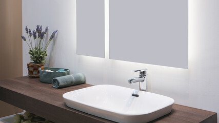 Fototapeta na wymiar White washbasin with faucet on wooden countertop in minimalist modern bathroom, scandinavian interior with stylish gray wall and round mirror. Copy space and nobody.