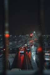 view from the bridge on moving cars in the city after dark (selective focus)