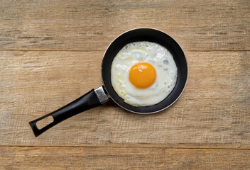 egg in casserole on wooden background