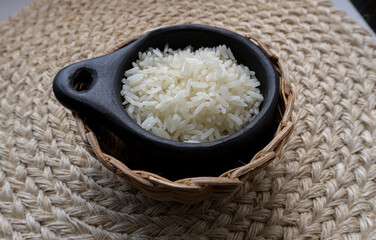 rice in black clay pot on individual fique