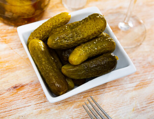 Traditional russian cuisine, preserved salted green cucumbers, served in a cafe