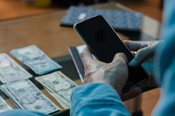 Financial planning made easy with mobile devices. A person who uses a cell phone to do their...
