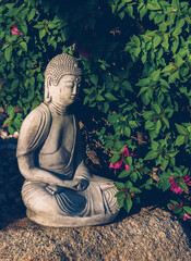 Zen Buddha in Garden on Rock