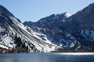 Snowy mountian peaks rise above Convict Lake in the Eastern Sierra, with scenery that is remniscient of the Swiss Alps