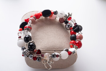 double  bracelet  with black and red  semipreciouse stones with natural lava, shungite,  hematite,  rhodonite, coral .  against white background