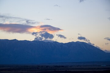 The sun sets over the Sierra Nevada Mountains, as seen from near Bishop, one of the larger cities in the Eastern Sierra region.