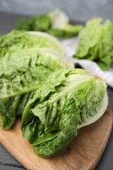 Fresh green romaine lettuces on grey wooden table, closeup