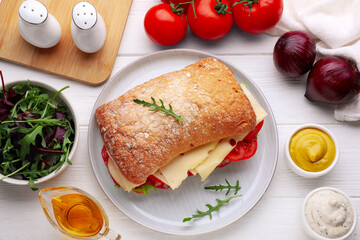 Delicious sandwich with tasty filling and ingredients on white wooden table, flat lay