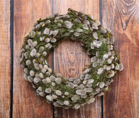 Wreath made of beautiful willow flowers on wooden table, top view © New Africa