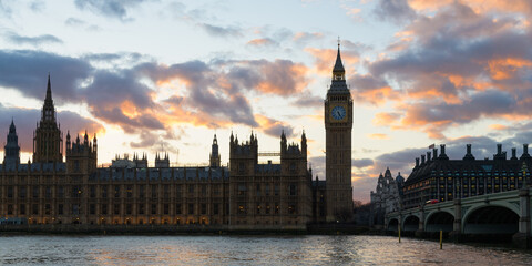 Panorama of backlit Palace of Westminster in London against sunset sky