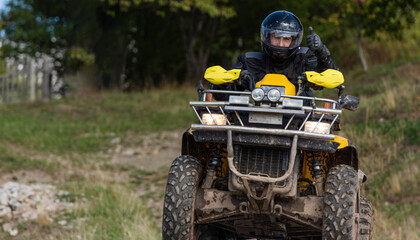 Adventurous driving of ATV motorbikes. A man drives a quad bike on dangerous roads