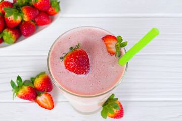 Strawberry yogurt fruit juice smoothie pink colorful fruit juice milkshake blend beverage healthy high protein the taste yummy In glass drink episode morning on white wood background.