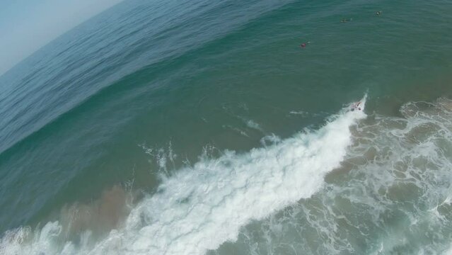 Bodyboarder executes a perfect rollo trick and continues riding should of wave