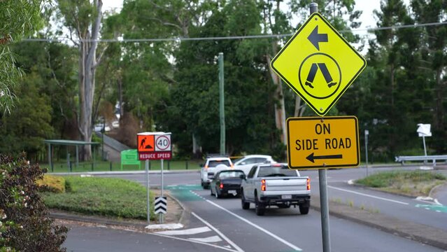 Road traffic cars stopping in an Australian suburb at cross junction