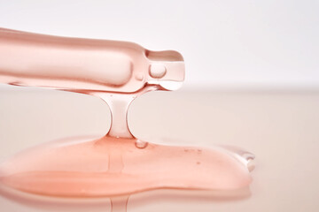 Pipette with a viscous pink cosmetic close-up.