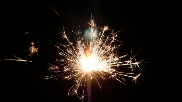 The brilliant spark produced when a firework stick is lit