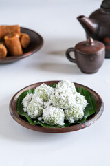 klepon or onde onde is Indonesian traditional cake made from glutinous flour and filled with palm sugar, covered with grated coconut