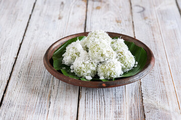 klepon or onde onde is Indonesian traditional cake made from glutinous flour and filled with palm sugar, covered with grated coconut