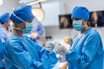 Professional doctors performing surgical operation in operating room. 