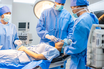 Professional doctors performing surgical operation in operating room. 