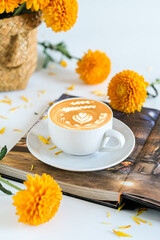 still life, acup of coffee and flower on a book
