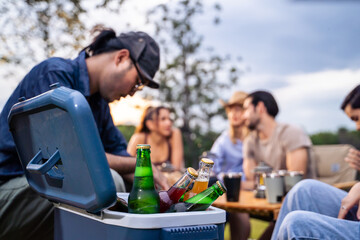Group of diverse friend having outdoors camping party together in tent. 